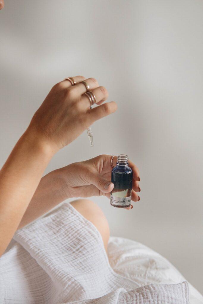 Person holding a serum shows how to build a skin cycling routine