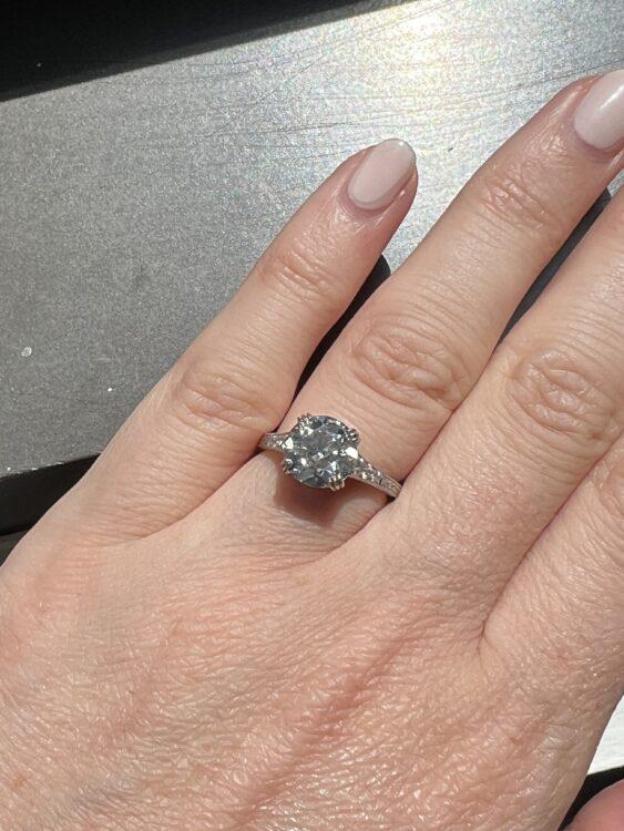 Art Deco Engagement Ring A shot of someone with manicured nails wearing an Art Deco engagement ring