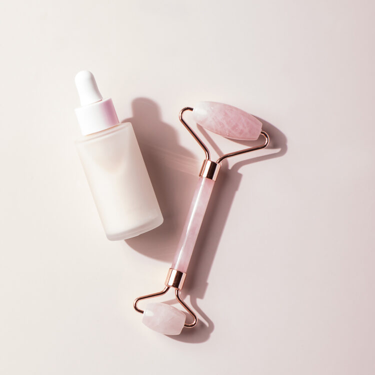 rose quartz race roller A rose quartz race roller next to a facial serum