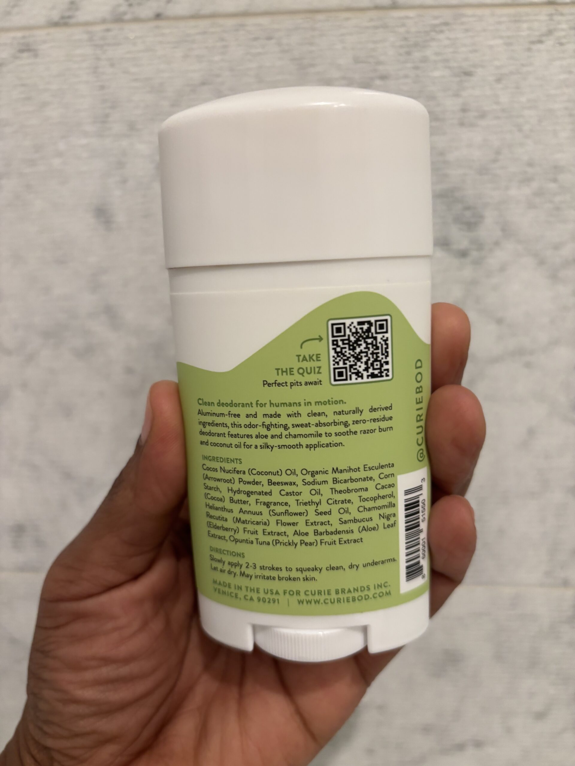 Curie Deodorant ingredients The ingredients list of a white stick of deodorant with a green label