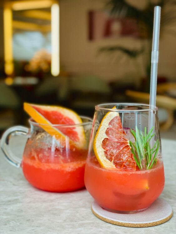 grapefruit and rosemary tonics A shot of two grapefruit and rosemary tonics in different glasses