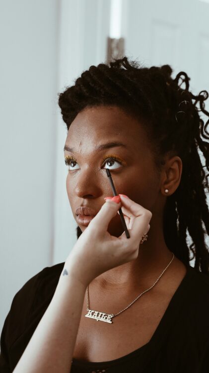 liner on waterline Person applying liner on the water line of someone else